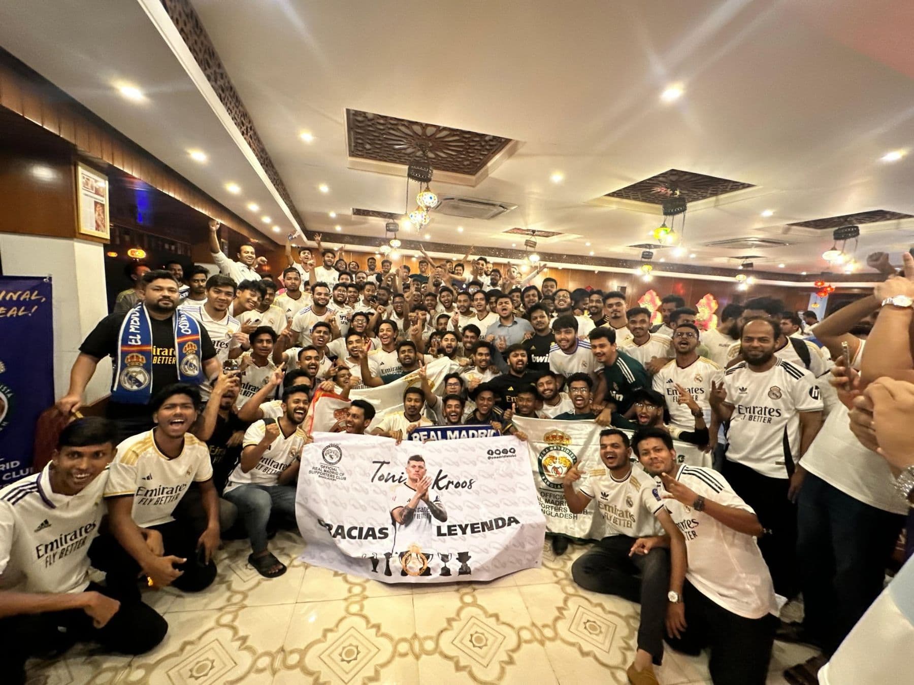 PMBD members celebrating with club banners and a Toni Kroos "Gracias Leyenda" banner at the 2024 Champions League final screening in Chittagong