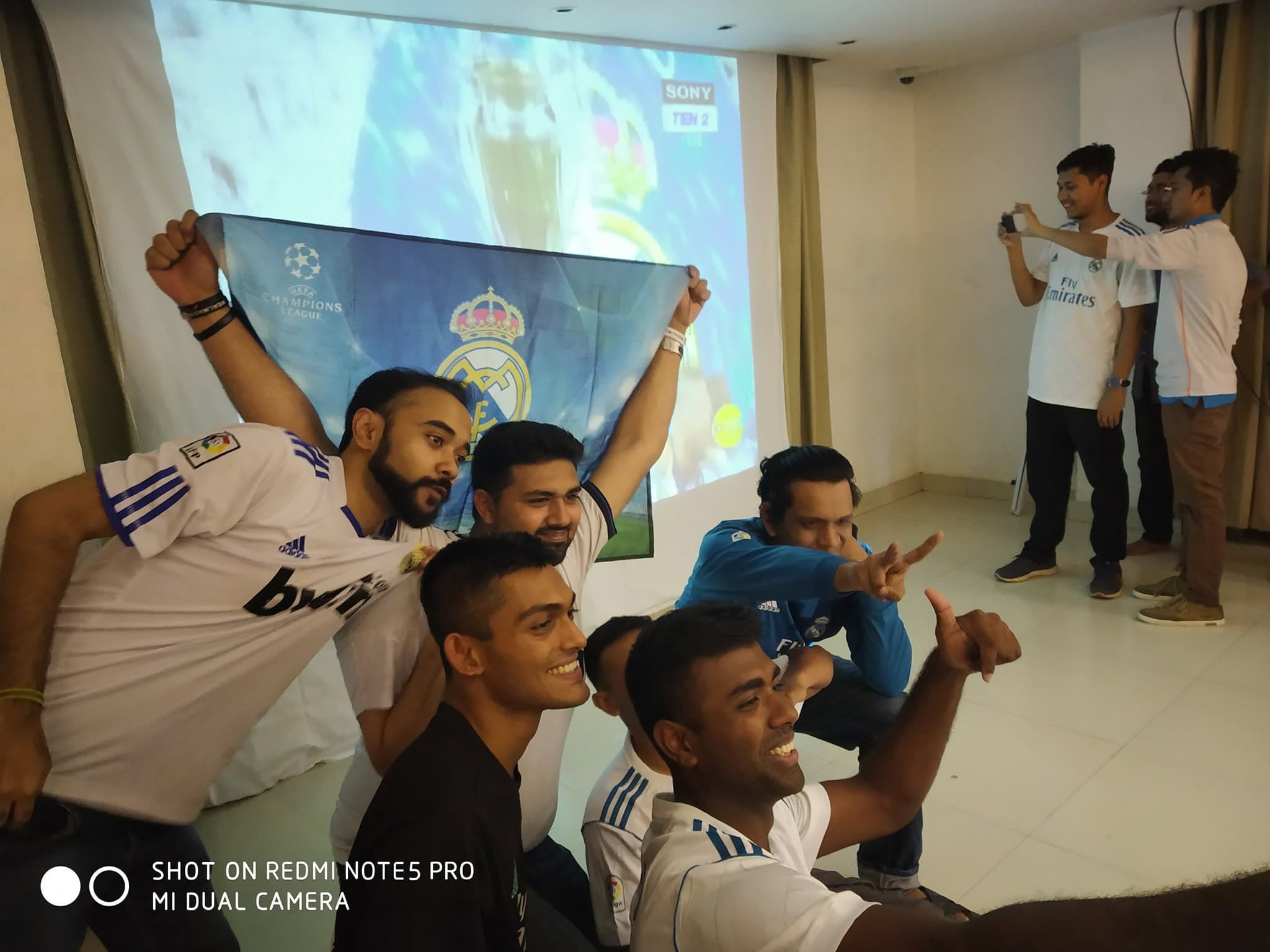 PMBD members celebrating with a Champions League banner during a live screening of the 2018 final, La Decimotercera